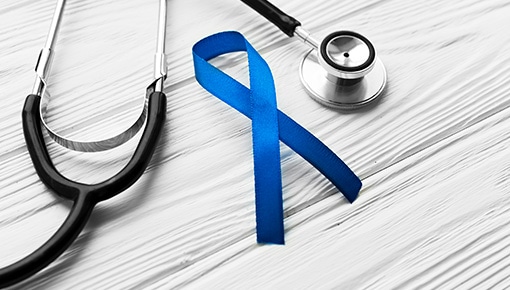 A blue awareness ribbon and a stethoscope.
