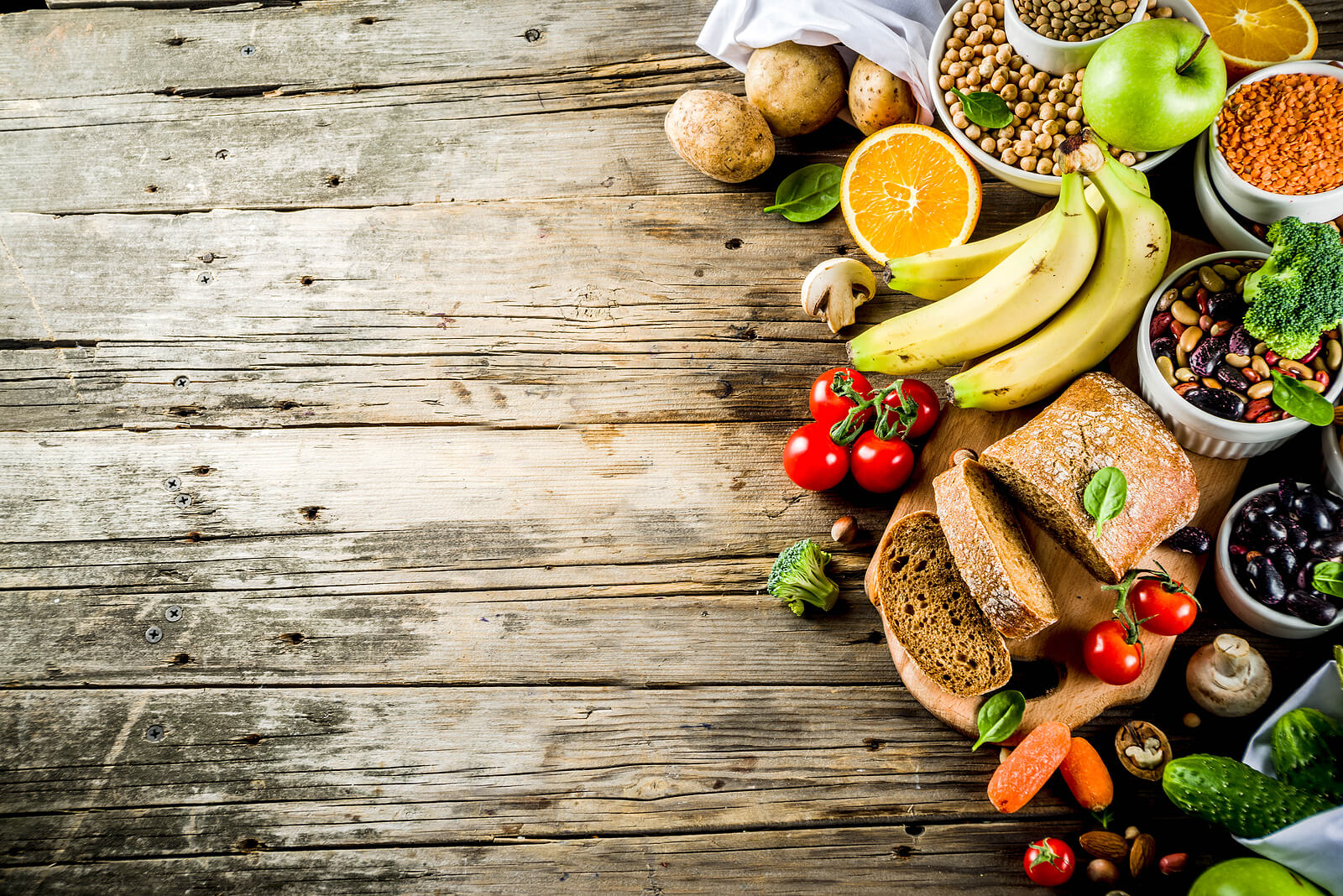 Variety of healthy foods on wooden background.