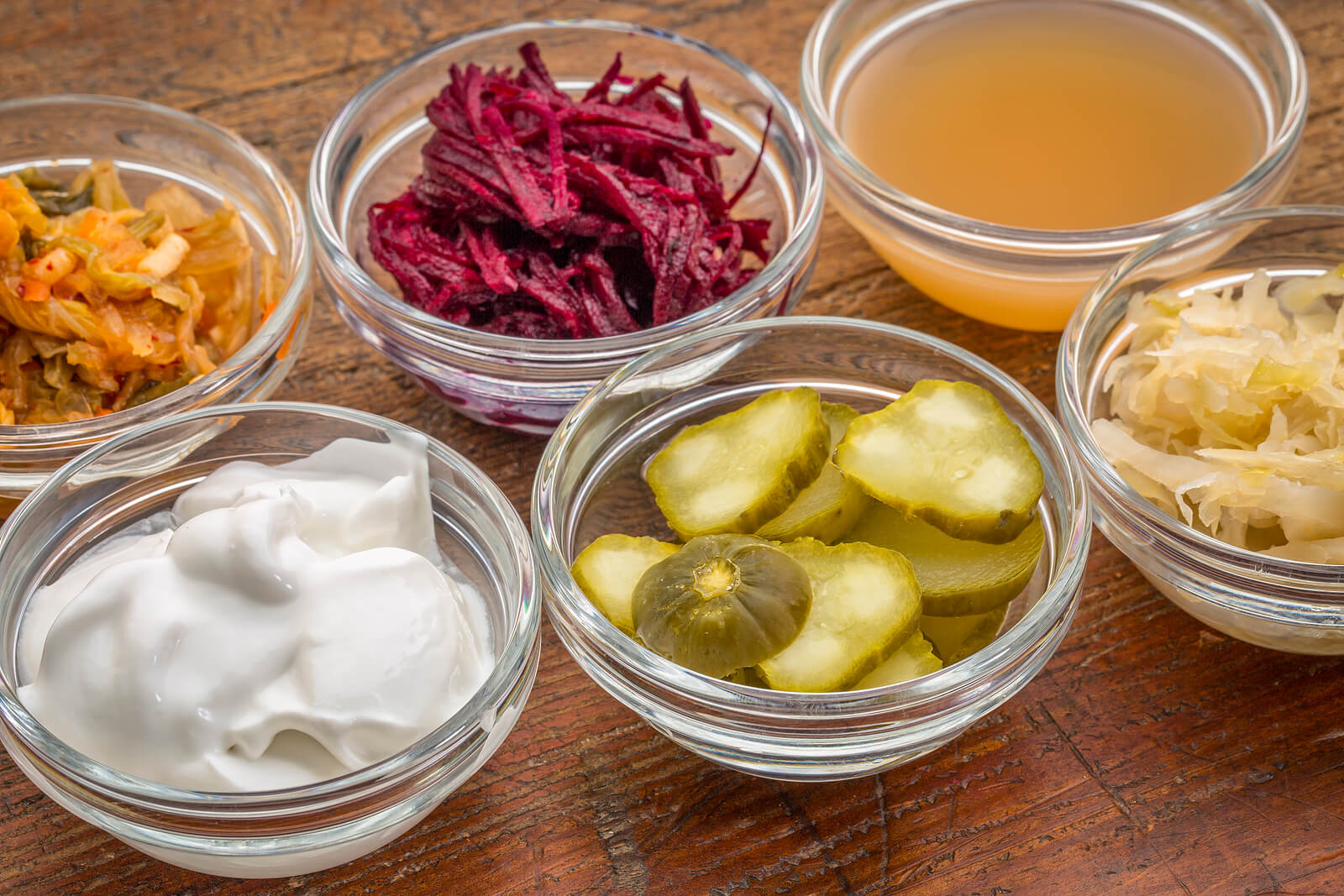 Variety of fermented foods in glass bowls.