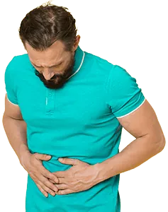 A woman in pain hunched over because of her stomach.