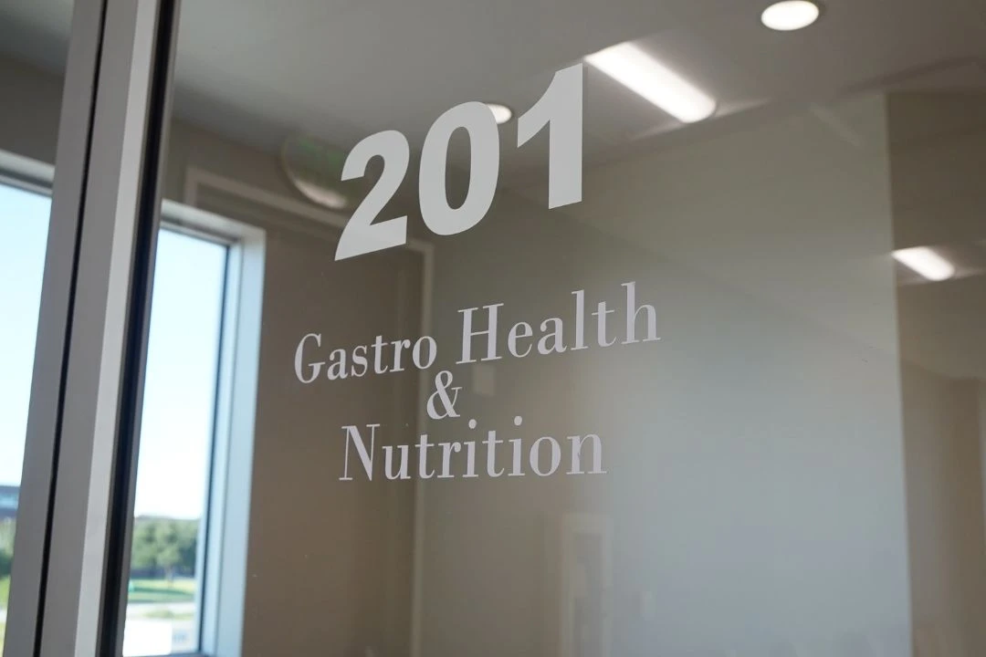 A glass door with the numbers "201" and the text "Gastro Health & Nutrition" indicating a medical office that specializes in gastrointestinal health and nutrition services.