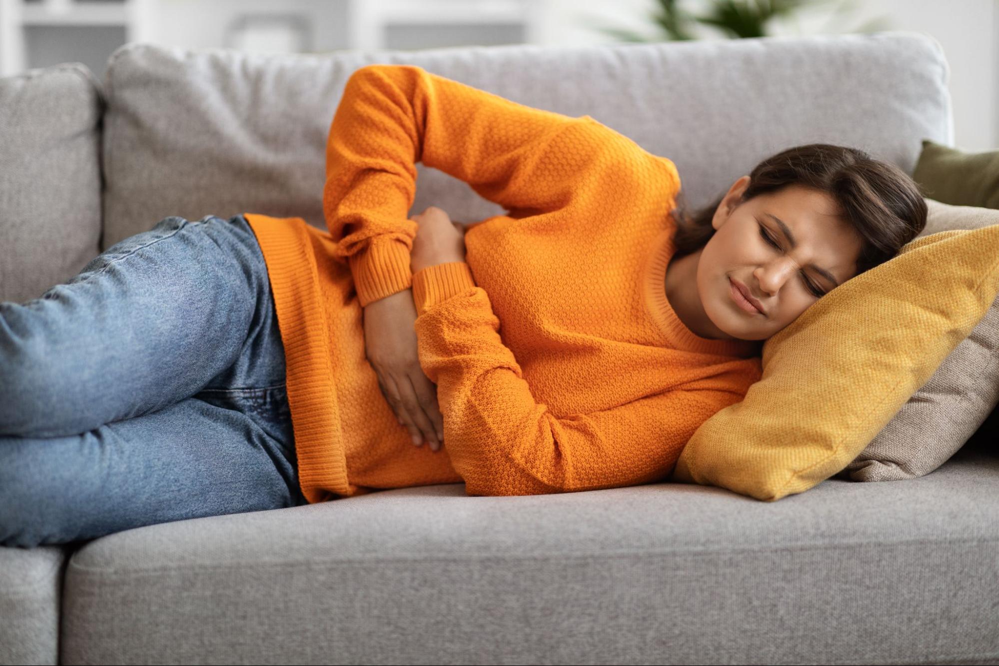 Woman lying with stomach pain.